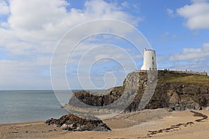 TÅµr Mawr lighthouse, on Ynys Llanddwyn on Anglesey, Wales, marks the western entrance to the Menai Strait.