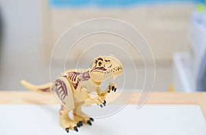 T rex or Tyranosaurus dinosaur toy in hunting posture photo