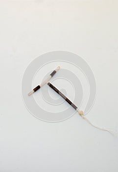 T shape IUD Gold hormon free birth control device on white background. Selective focus