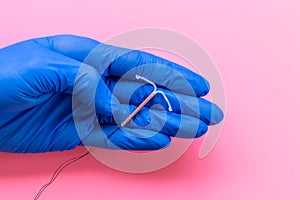 T-shaped intrauterine contraceptive device in gynecologist hand