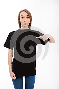 T-shirt design, happy girl concept of smiling woman in blank template black shirt pointing her fingers at herself.