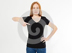 T-shirt design, happy people concept - smiling red hair woman in blank black t-shirt pointing her fingers at herself, red head