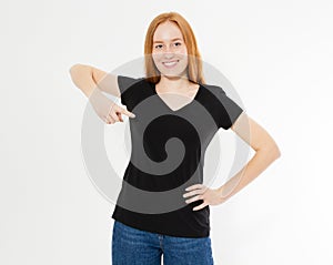 T-shirt design, happy people concept - smiling red hair woman in blank black t-shirt pointing her fingers at herself, red head