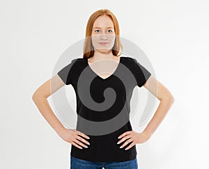 T-shirt design, happy people concept - smiling red hair woman in blank black t-shirt pointing her fingers at herself, red head