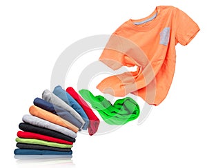 T-shirt flies out of a pile with clothes on white background