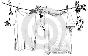 T-shirt and sleeveless t-shirt hanging on linen rope on wooden clothespins
