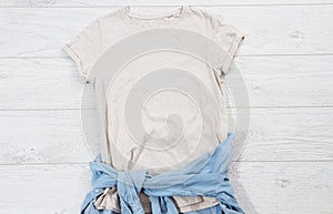 T-shirt top view, t shirt mock up, empty tshirt. Summer concept casual clothes background copy space. Blank shirt on wooden