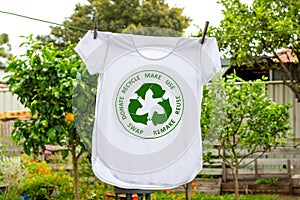 T shirt on washing line with circular economy textiles icon, make, use, reuse, swap, donate, recycle with eco clothes recycle icon