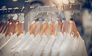 T-shirts on hangers. Stacks of clothes. Shopping in store. Clothes on hangers in shop for sale