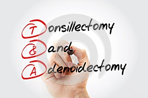 T&A - Tonsillectomy and Adenoidectomy acronym with marker, concept background
