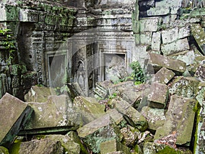 Ta Prohm Temple with collapsed stone structure and fine hindu sculpture in background, Angkor, Siem Reap Province, Cambodia