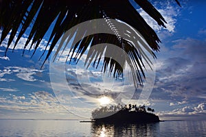 Taakoka islet and palm tree at dusk in Muri lagoon Rarotonga Coo