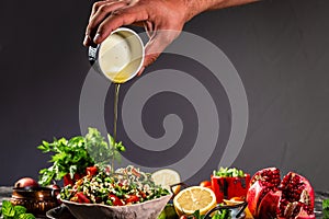 Tabbouleh Levantine vegetarian salad made of chopped parsley, with tomatoes, mint, onion and bulgur, and seasoned with olive oil,