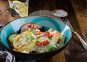 Tabbouleh salad on dark wooden background