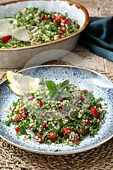 Tabbouleh salad onion tomato and parsley in ceramic dish photo