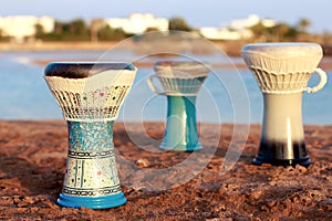 Tabla or darbuka, egyptian music instrument, beach background