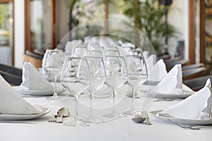 Table arrangement with polished cutlery on each side of elegant crookery, complemented by a cone-shaped cotton napkin