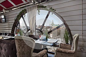 Table with a bar in the restaurant with panoramic windows. Elegant appearance, wine glasses, chic romantic atmosphere, bright day