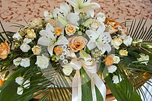 On the table is a beautiful large bouquet of flowers, a decoration for a wedding ceremony or banquet decoration.