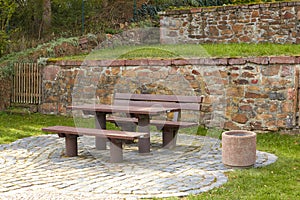 A table with benches for rest. Resting place in nature. The forest rest area is made of wood. Table and bench for people in nature