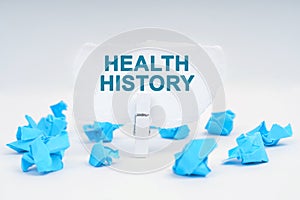 On the table are blue pieces of paper and paper with the inscription - HEALTH HISTORY