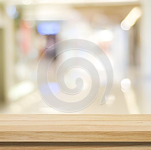 Table and blur background, Wooden counter over blur bokeh light background, Brown wood table top, shelf for food and retail shop,