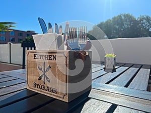 A table in a cafe or restaurant with napkins, forks, knives