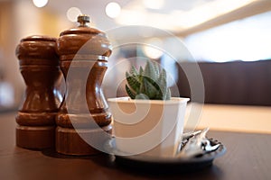 Table in a cafe or restaurant Wooden style salt and pepper spice jars on wooden table
