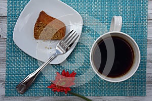 Table cake with coffee mug and Gerbera daisy flower