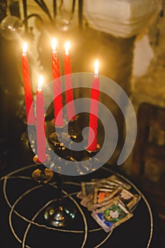 Table with candles and cards for fortune telling. Witch ritual concept.