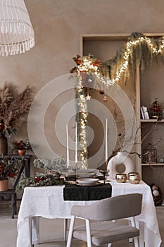 Table with candles, decor, tableware in room