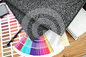 On table are carpet samples bright color palette