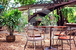 Table and chair are outdoor in coffee shop.