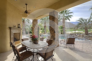 Table and chair in patio of luxury manor house