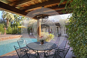 Table and chair at poolside in mansion