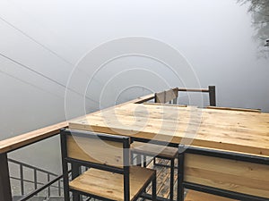 Table and a chair of the summer restorant in fog