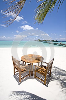 Table and chairs on beach