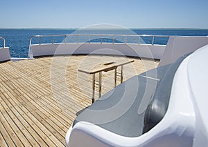 Table and chairs on bow deck of a luxury motor yacht