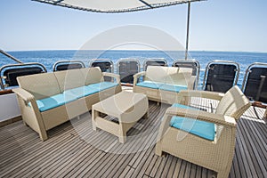 Table and chairs on deck of a luxury motor yacht