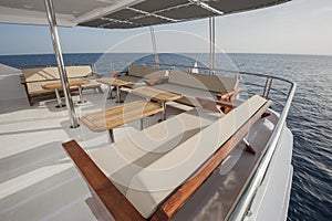 Table and chairs on deck of a luxury motor yacht