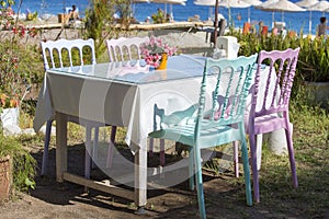 Table and chairs in empty cafe near the beach. Cirali, Kemer, Turkey