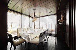 Table and chairs in empty restaurant photo