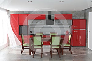 Table and Chairs in Front Of Modern Red Kitchen Furniture with Kitchenware Interior. 3d Rendering