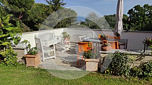 a table with chairs in the garden, with a view of the mountains