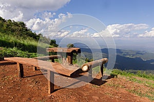 Table and chairs with grass, mountain and cloudy sky view of Chi