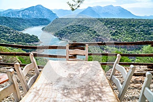 Table with chairs in the middle of nature overlooking the lake