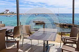 Table and chairs overlooking the bay and Puerto Portals of Majorca. Balearic islands