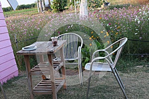 Table and chairs at the relaxation corner  Outdoor for drinking coffee beautiful flower garden background.