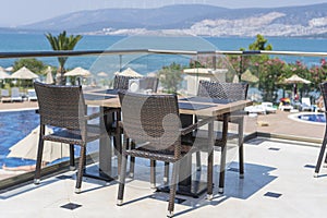 Table and chairs in restaurant , Turkey. Beach cafe near sea, outdoors. Travel and vacation concept