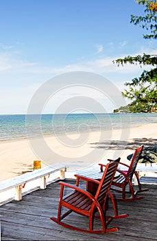 Table with chairs. On the sandy beach